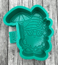 A green silicone mold depicting a gnome with a beach theme, including a hat and a surfboard.