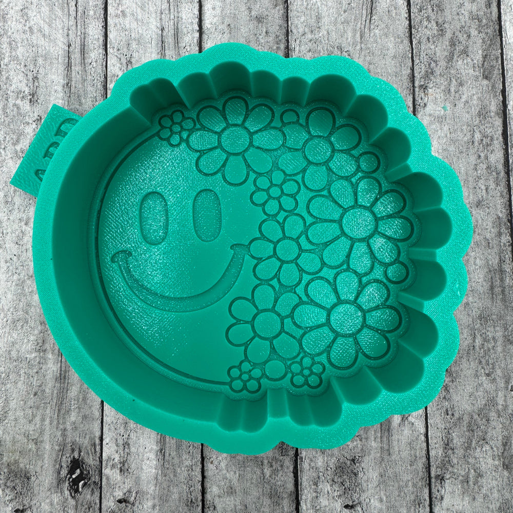 Teal silicone mold with floral design and smile face